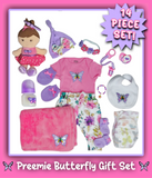 A pink and purple, preemie sized, butterfly themed baby outfit surrounded by butterfly themed doll accessories to match for reborn or silicone dolls. 